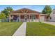 Charming single-story home with covered porch, mature lawn, and easy access walkway to entry door at 11192 E 7Th Ave, Aurora, CO 80010