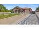 Charming single-story home with covered porch, long driveway, and attached one car garage at 11192 E 7Th Ave, Aurora, CO 80010