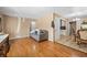 Open-concept living room with wood floors leading to adjacent kitchen and dining area at 11192 E 7Th Ave, Aurora, CO 80010
