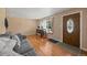 Bright living room with wood-look floors, a sofa, and a front door with an oval window at 11192 E 7Th Ave, Aurora, CO 80010