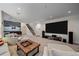 Spacious basement featuring a media area with large TV and a wet bar, perfect for entertaining at 3323 W Hayward Pl, Denver, CO 80211