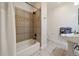 Full bath featuring tiled shower and tub combination with a pedestal sink and neutral color palette at 3323 W Hayward Pl, Denver, CO 80211