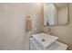 Modern powder room featuring a stylish sink, square mirror, and a crisp, clean design at 3323 W Hayward Pl, Denver, CO 80211