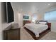 Well-lit bedroom showcasing a comfortable bed, dresser, and modern decor at 3323 W Hayward Pl, Denver, CO 80211