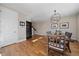 Bright dining room featuring hardwood floors, modern lighting, and open access to the staircase at 3323 W Hayward Pl, Denver, CO 80211