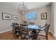 Bright dining room with a modern chandelier, large window, and hardwood floors, perfect for entertaining at 3323 W Hayward Pl, Denver, CO 80211