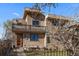 Attractive home with stone and stucco exterior, front yard seating area, and a balcony offering an inviting curb appeal at 3323 W Hayward Pl, Denver, CO 80211