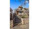 Beautiful home with a stone and stucco facade, inviting entryway, and a balcony, complemented by professional landscaping at 3323 W Hayward Pl, Denver, CO 80211