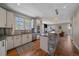 Well-lit kitchen featuring stainless steel appliances, stone counter, and open layout at 3323 W Hayward Pl, Denver, CO 80211