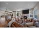Inviting living room with a stone fireplace, large TV, and comfortable leather seating at 3323 W Hayward Pl, Denver, CO 80211