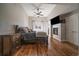 Cozy main bedroom with a fireplace, TV, and hardwood floors, creating a relaxing retreat at 3323 W Hayward Pl, Denver, CO 80211
