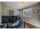 Bright office featuring a modern desk, hardwood floors, and chandelier at 3323 W Hayward Pl, Denver, CO 80211