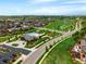 Aerial view showcasing the community pool, playground, and walking paths amidst homes at 10185 Isle St, Parker, CO 80134