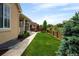 Grassy backyard and walkway leading to a patio for relaxation, gardening or entertaining at 10185 Isle St, Parker, CO 80134