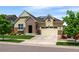 Attractive single-Gathering home featuring a brick facade, a two-car garage, and a well-manicured lawn at 10185 Isle St, Parker, CO 80134