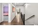 Hallway with wood floors and decorative staircase leads to the bedrooms and living areas at 10185 Isle St, Parker, CO 80134