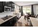 Eat-in kitchen featuring dark cabinets, stainless steel appliances, granite countertops, and a sliding glass door at 10185 Isle St, Parker, CO 80134