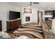 Comfortable living area featuring dark wood floors, a fireplace, and a large television at 10185 Isle St, Parker, CO 80134