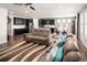 Spacious open-concept living area with dark hardwood floors seamlessly integrates with a modern kitchen at 10185 Isle St, Parker, CO 80134
