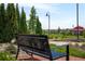Park bench overlooking walkways, lush green spaces, a gazebo, trees, and community homes at 10185 Isle St, Parker, CO 80134