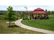 Community park with a gazebo, picnic tables, and walking path amidst green lawn at 10185 Isle St, Parker, CO 80134