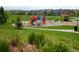 View of the community playground with colorful play structures and ample green space at 10185 Isle St, Parker, CO 80134