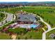 Aerial view of a community pool with lounge chairs and umbrellas surrounded by trees at 10185 Isle St, Parker, CO 80134