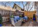 Backyard patio area with conversation set and privacy fence at 723 W 5Th Ave, Denver, CO 80204