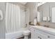 Bathroom with white subway tile, shower with tub, and white vanity with framed mirror at 723 W 5Th Ave, Denver, CO 80204