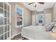 Bedroom featuring a cozy bed, ceiling fan, and a view from the window at 723 W 5Th Ave, Denver, CO 80204