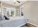 Well-lit bedroom featuring a cozy bed with a view of the living room at 723 W 5Th Ave, Denver, CO 80204