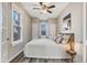 Comfortable bedroom featuring a ceiling fan, accent wall art, and warm natural lighting at 723 W 5Th Ave, Denver, CO 80204