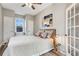 Bright bedroom with modern ceiling fan, neutral walls, and view to the living room at 723 W 5Th Ave, Denver, CO 80204