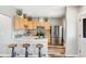 Bright kitchen with stainless steel appliances, a breakfast bar with seating, and modern finishes at 723 W 5Th Ave, Denver, CO 80204