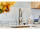 Close-up of the kitchen sink featuring a modern faucet and granite countertop, highlighting the kitchen's updated features at 723 W 5Th Ave, Denver, CO 80204