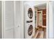 Laundry area features stacked washer/dryer unit and louvered closet doors at 723 W 5Th Ave, Denver, CO 80204