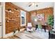 Home office features exposed brick wall and hardwood floors at 723 W 5Th Ave, Denver, CO 80204