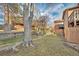 Spacious backyard featuring well-maintained lawn and wooden retaining wall at 9411 W 89Th Cir, Westminster, CO 80021