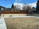 Outdoor basketball court with two hoops, a bench, and a wooden fence, perfect for recreational activities at 9411 W 89Th Cir, Westminster, CO 80021