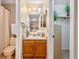 Well-maintained bathroom with tiled floors, linen closet, and wooden cabinets at 9411 W 89Th Cir, Westminster, CO 80021