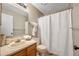 Bathroom with a shower and tub combination, neutral decor, and vanity storage at 9411 W 89Th Cir, Westminster, CO 80021