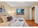 Bedroom with neutral tones and wood floor features a double bed and closet at 9411 W 89Th Cir, Westminster, CO 80021