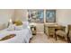 Bright bedroom featuring a study desk, window, and view of the surrounding neighborhood at 9411 W 89Th Cir, Westminster, CO 80021