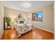 Relaxing bedroom features hardwood flooring, neutral decor, and lots of natural light at 9411 W 89Th Cir, Westminster, CO 80021