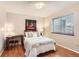 Bright bedroom featuring hardwood floors, a functional desk, and a comfortable bed at 9411 W 89Th Cir, Westminster, CO 80021