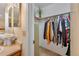 Walk-in closet showcasing ample storage space, and conveniently located next to the bathroom at 9411 W 89Th Cir, Westminster, CO 80021