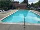 View of a spacious outdoor community pool with lounge chairs and seating areas for relaxation at 9411 W 89Th Cir, Westminster, CO 80021