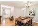 Charming dining room with natural light, hardwood floors, and a cozy bench by the front door at 9411 W 89Th Cir, Westminster, CO 80021