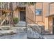 Inviting entrance with a brown door, steps, and a stone wall enhancing curb appeal at 9411 W 89Th Cir, Westminster, CO 80021