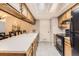 Practical kitchen boasts ample counter space, black appliances, and access to the dining area at 9411 W 89Th Cir, Westminster, CO 80021